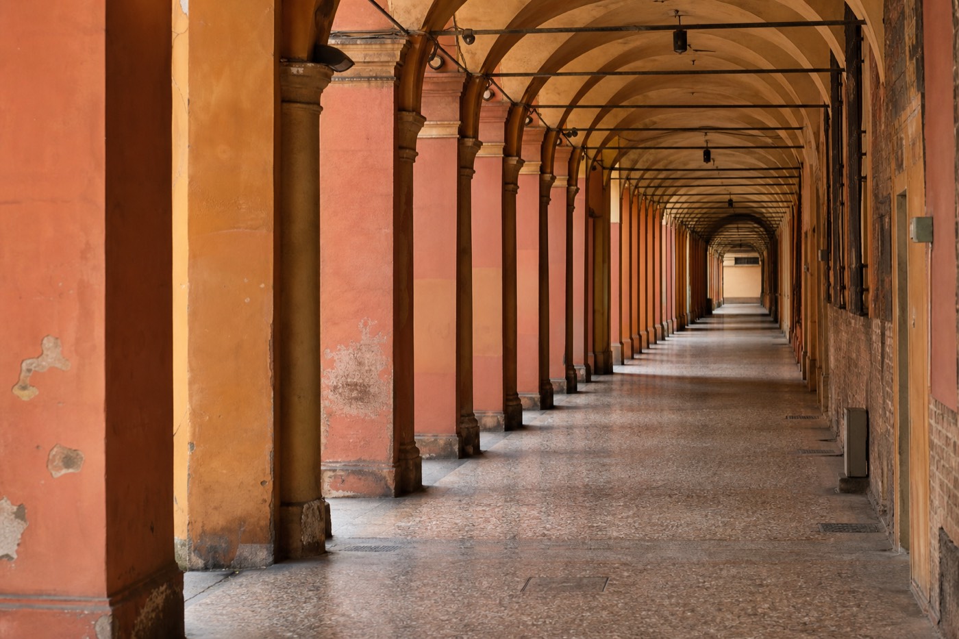 Bologna's historic porticoed streets near the train station connecting to Parma