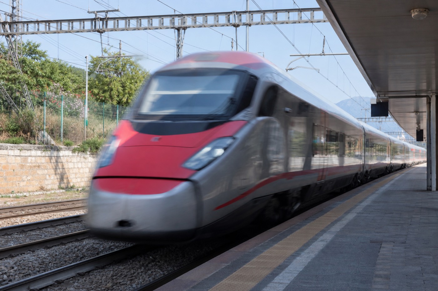 A Trenitalia train arriving at a platform, the way most visitors reach Parma from Milan, Bologna, Florence or Venice