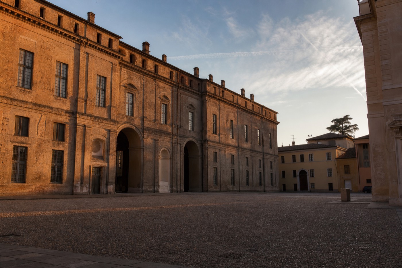 Parma Cathedral and the Baptistery seen across Piazza Duomo on a clear afternoon